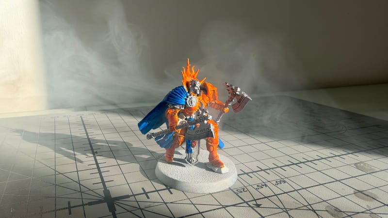 My first painted Reclusian: bright orange armour, a blue cloak and a big axe, on a white base.